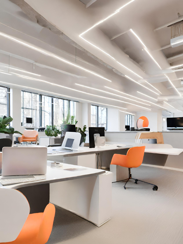 Refurbished work space with workbench and chairs with LED lighting in roof.